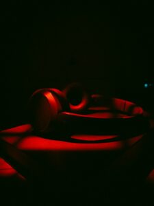 Red illuminated headphones on a dark surface